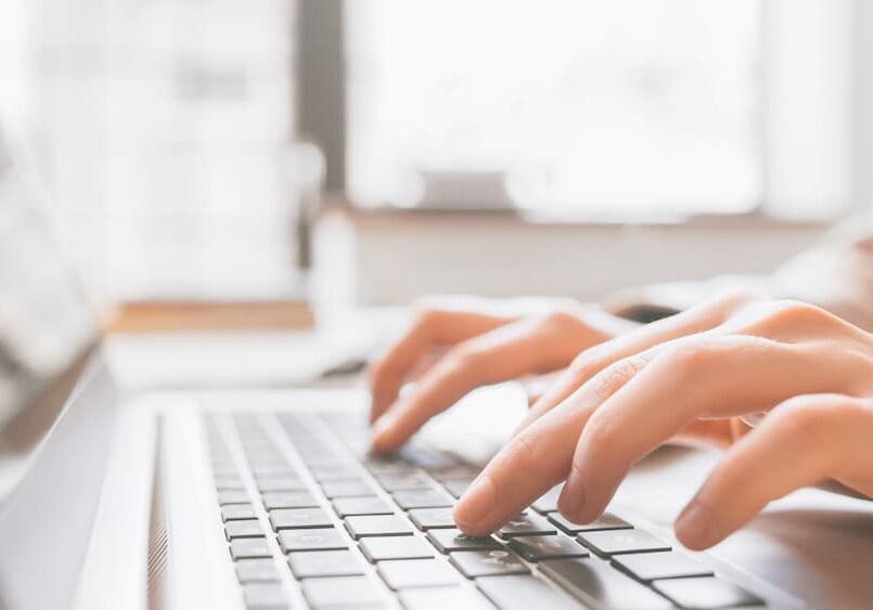 Person typing on keyboard